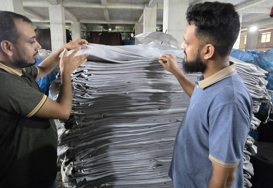 Two members of our team checking a stack of crust hides for grade and quality